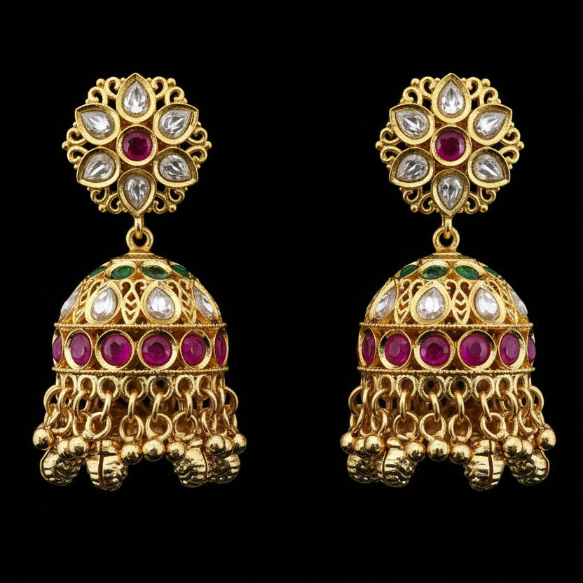 Gold earrings with red and green gemstones on a beige stand, SJNX-CODE-V-220 visible.