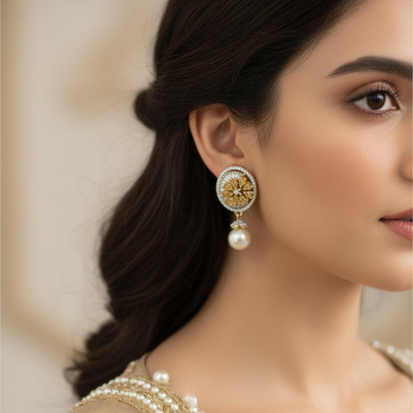 Gold and pearl earrings on a black background with 'SAHELLI' branding.