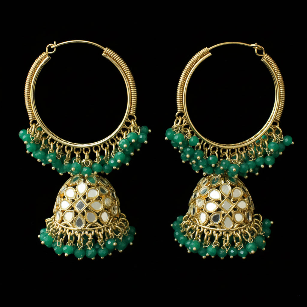 Gold and green hoop earrings on a black stand