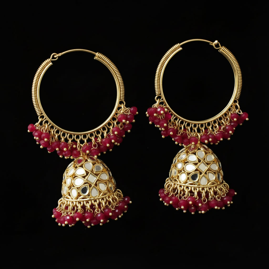 Gold and red beaded earrings on a black background