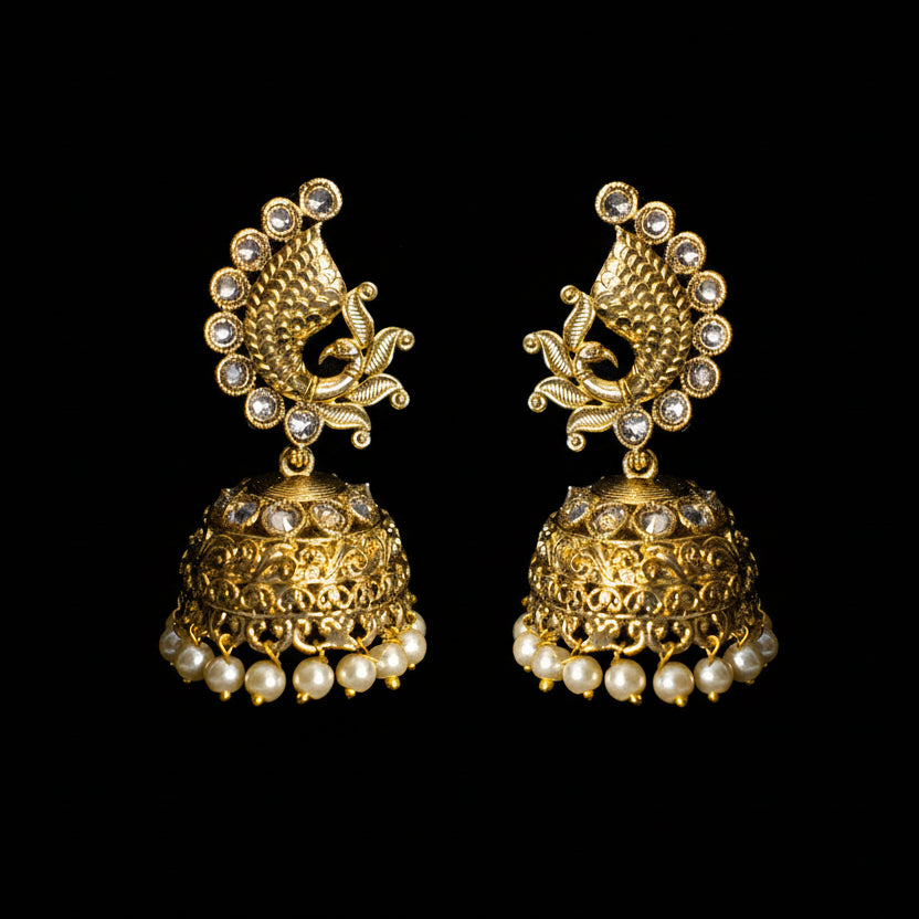 Gold and pearl earrings on a black background with 'Saheli' branding.