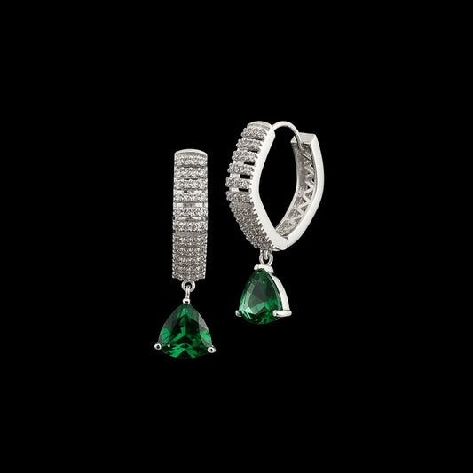 Pair of earrings with green gemstones and silver accents on a gray background, branded 'SAHELI'.