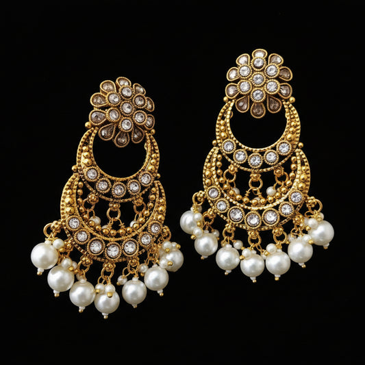 Gold and pearl earrings on a gray background with 'SAHELI' branding.