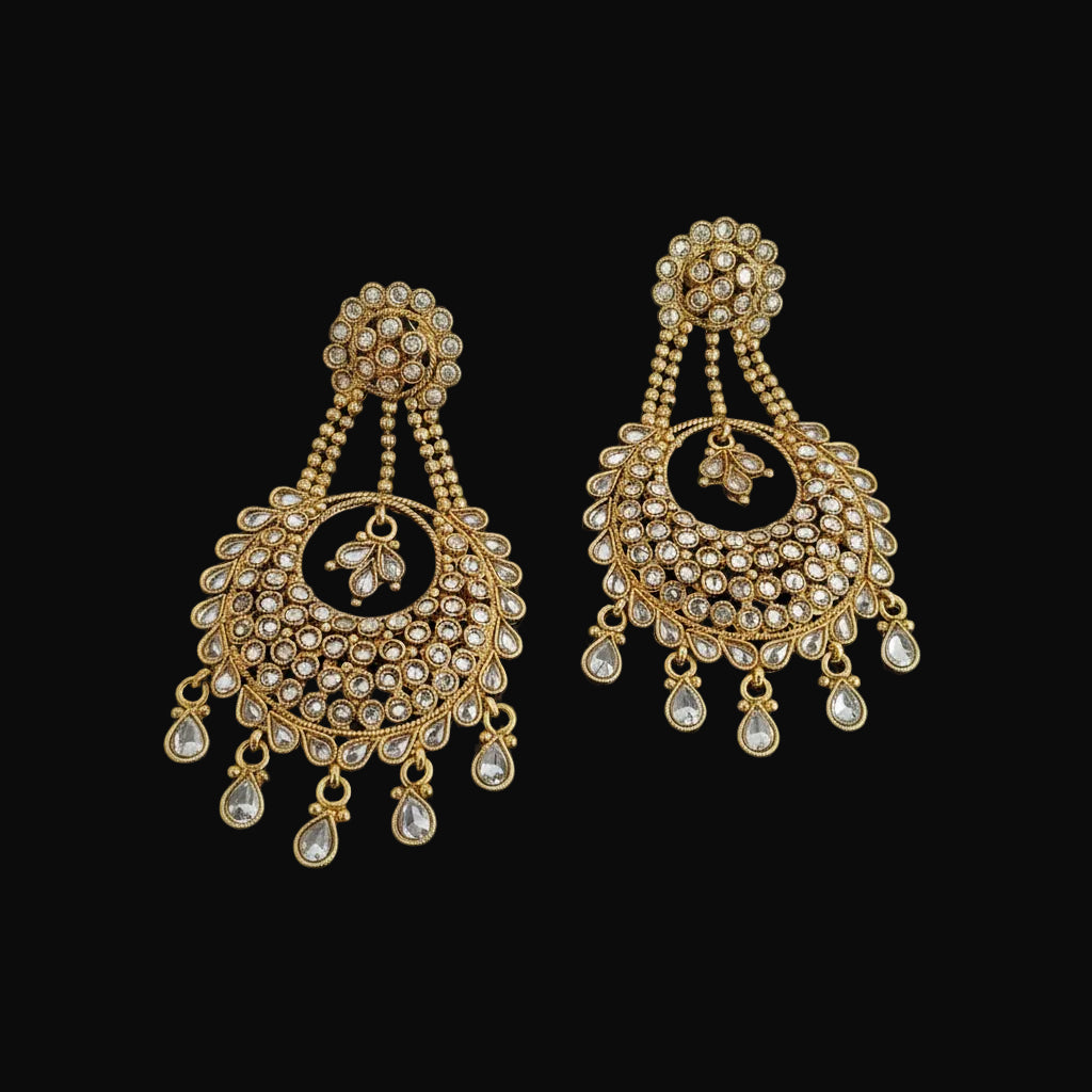 A pair of gold-toned traditional Indian chandelier earrings embellished with clear crystals, displayed on a dark gray background with the brand name 'SAHELI MY BEST FRIEND' printed above.