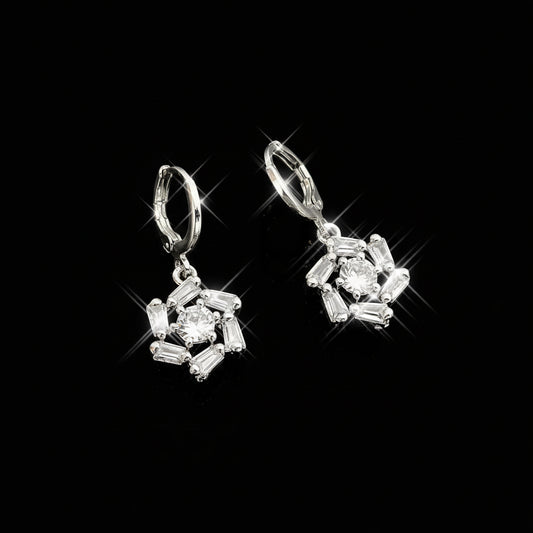 Silver earrings with gemstones on a gray background, featuring the brand 'Saheli'.