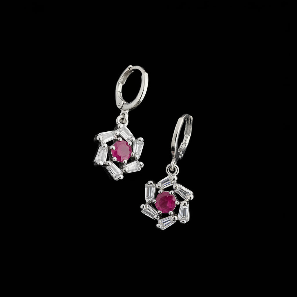 Silver earrings with pink gemstones on a gray background, featuring the brand 'Saheli'.