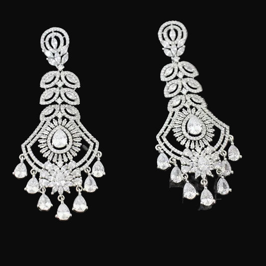 Pair of silver chandelier earrings on a dark background