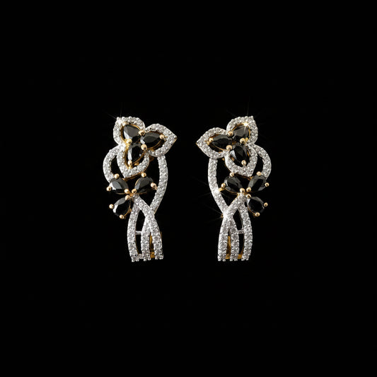 Pair of diamond earrings on a dark gray stand with 'Saheli' branding.