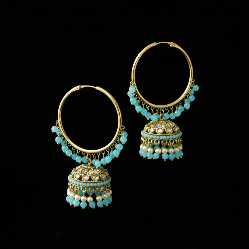 Pair of gold and turquoise beaded earrings on a black background