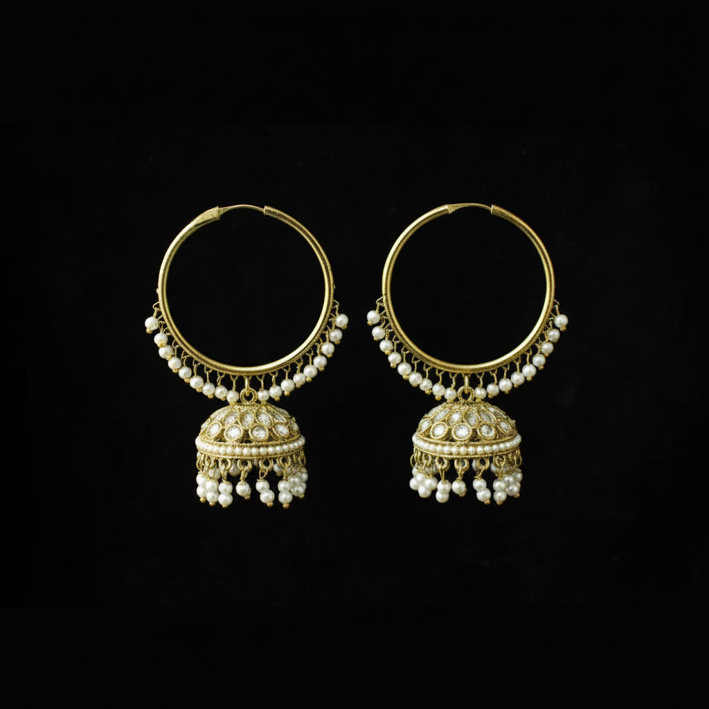Pair of gold hoop earrings with pearl drops on a black background
