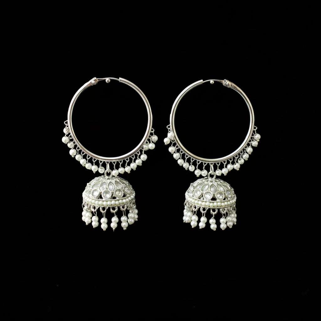Pair of silver hoop earrings with pearl-like beads on a black background