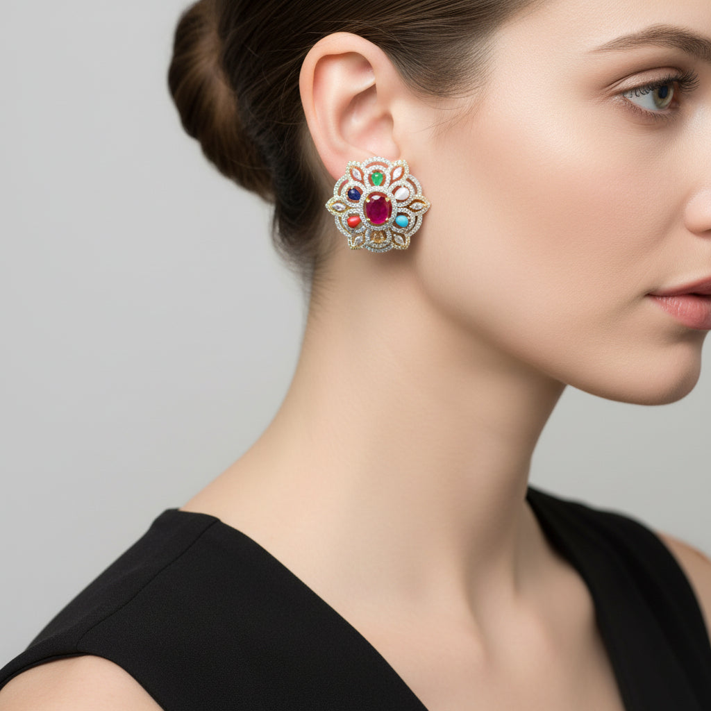 Pair of ornate earrings with gemstones on a dark background