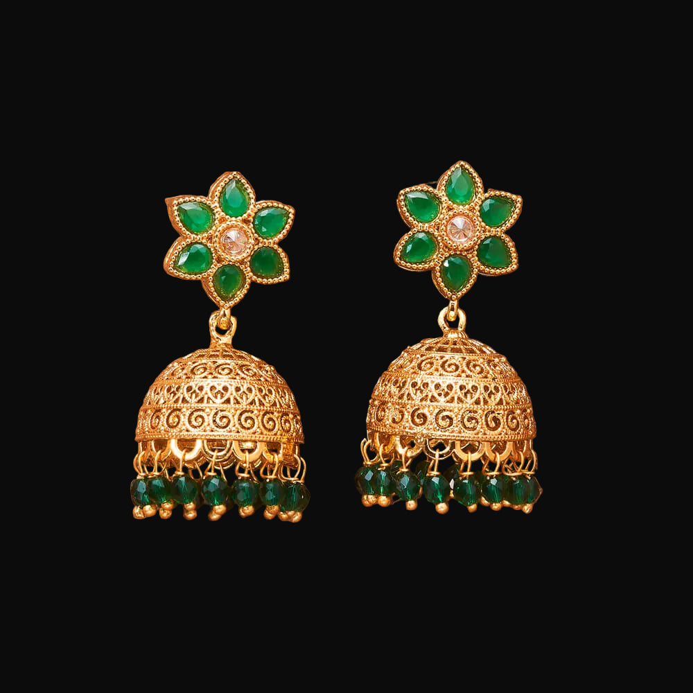Gold and green earrings on a brown background