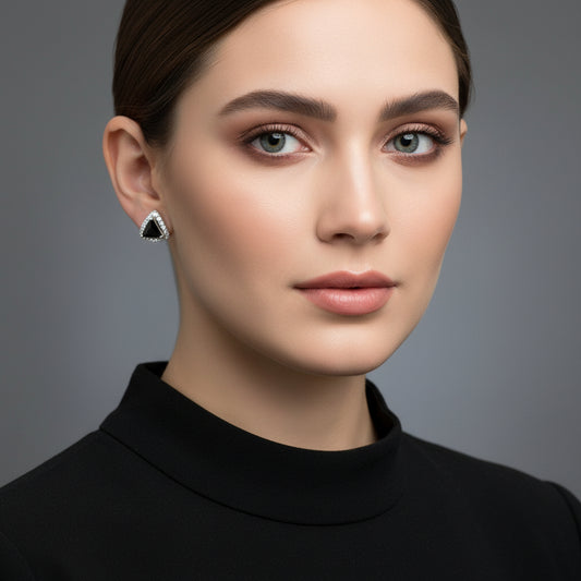 Silver earrings with black stones on a gray cushion, branded 'Saheli My Best Friend' on a dark background.
