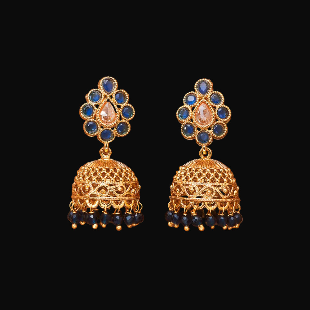 Gold and blue earrings on a brown background