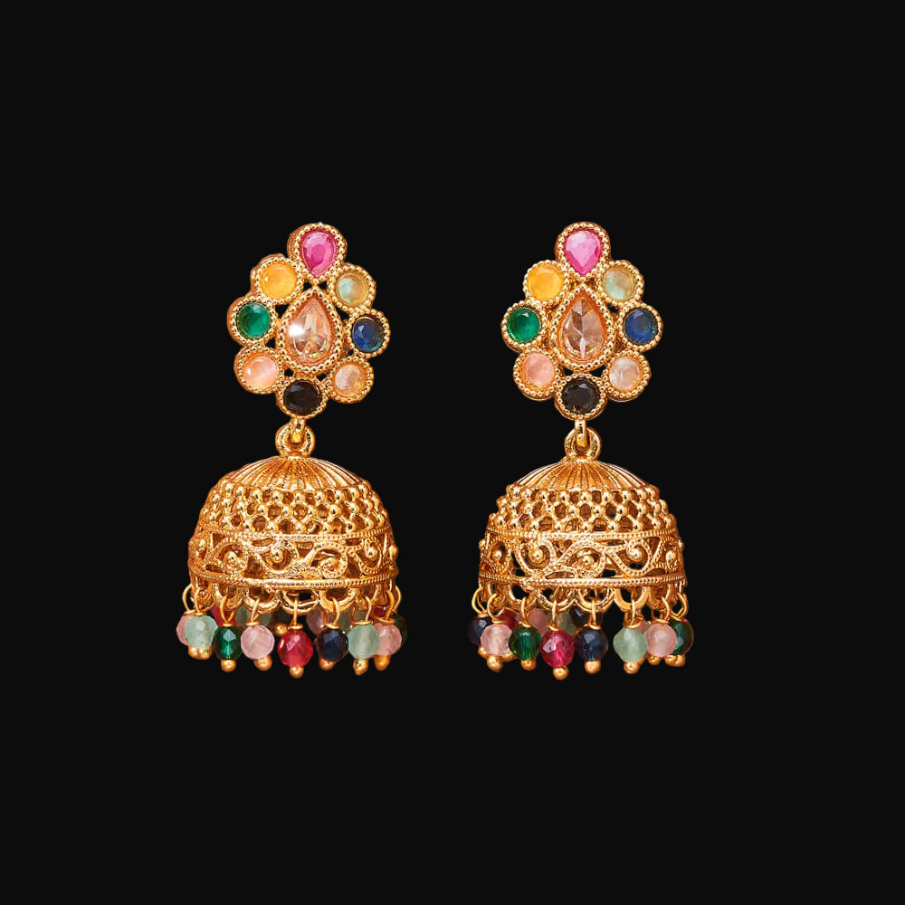 Pair of gold earrings with colorful gemstones on a brown background