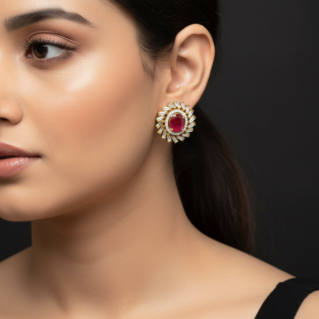 Gold and red gemstone earrings on a dark background with 'Saheli' branding.