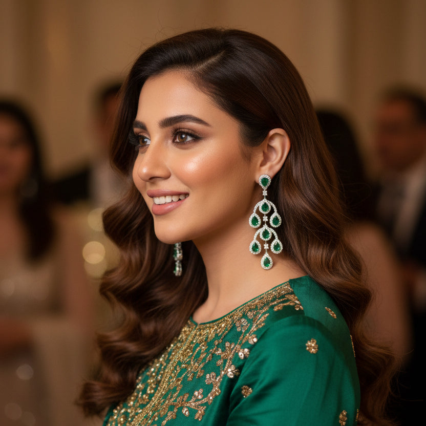 Pair of green gemstone earrings on a dark background