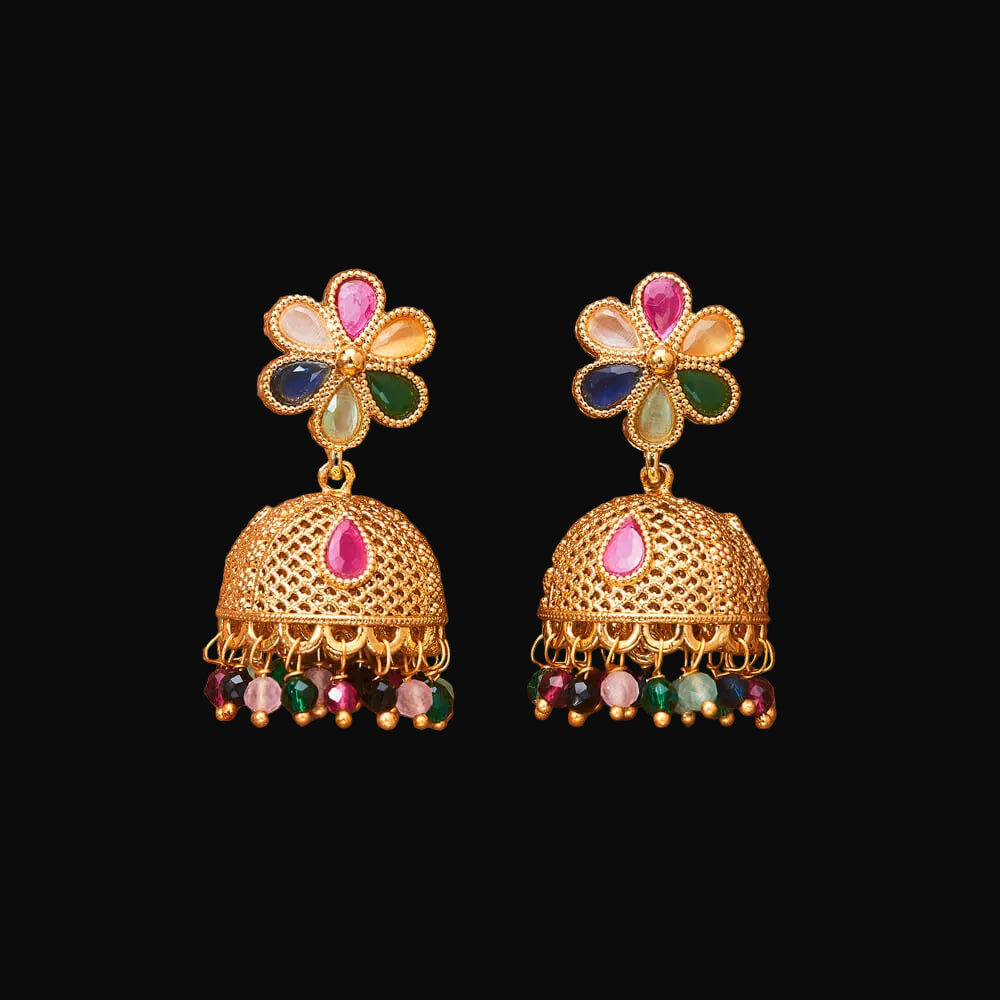 Gold earrings with colorful gemstones on a brown background