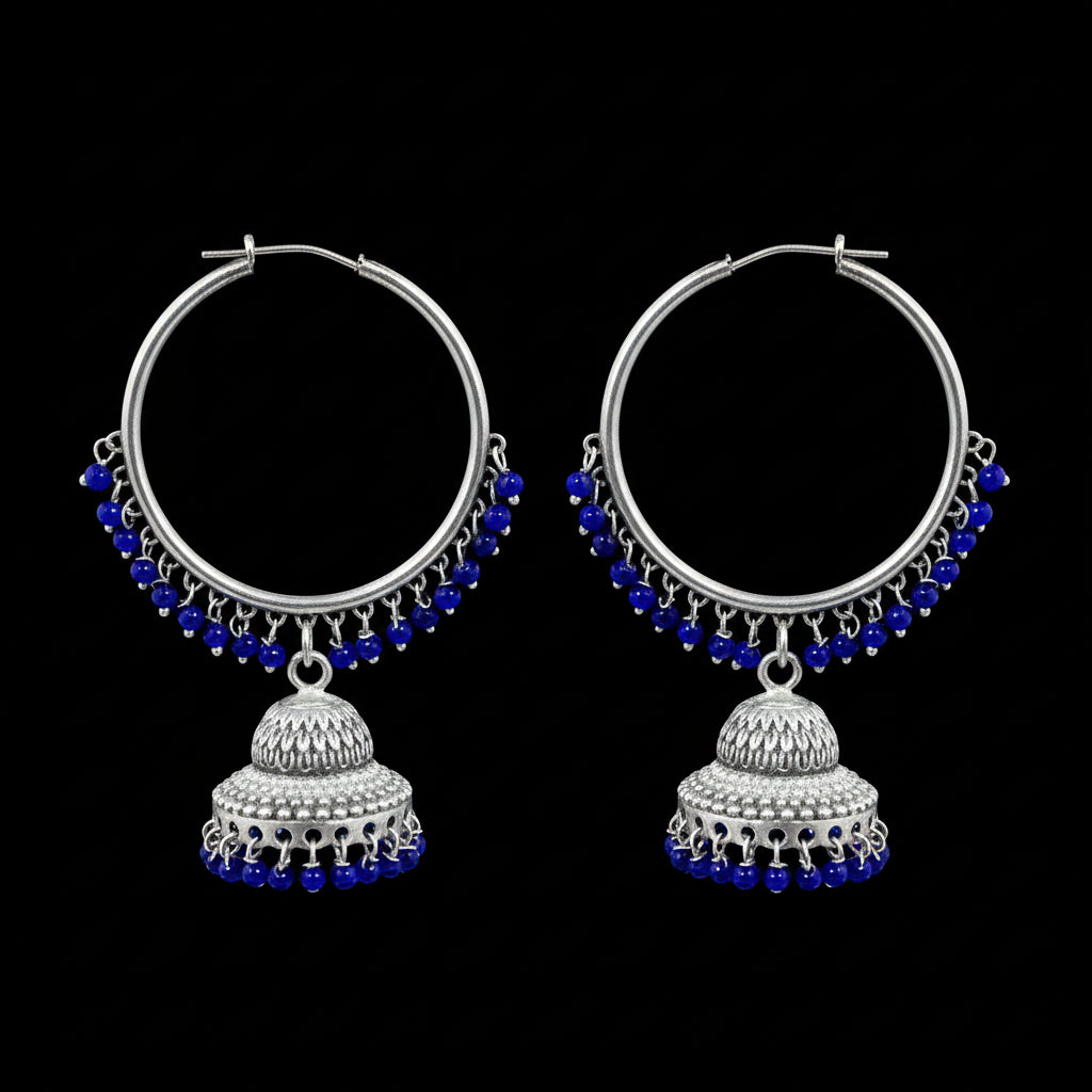 Silver hoop earrings with blue beads and jhumkas on a black background, branded 'Saheli'.