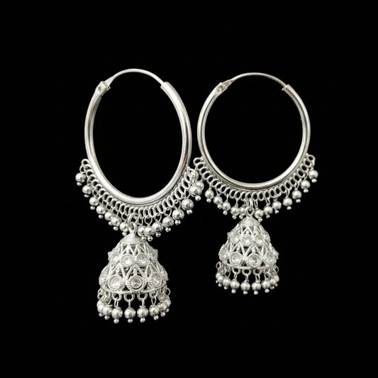Silver hoop earrings with dangling elements on a gray background, featuring the brand 'SAHELI'.