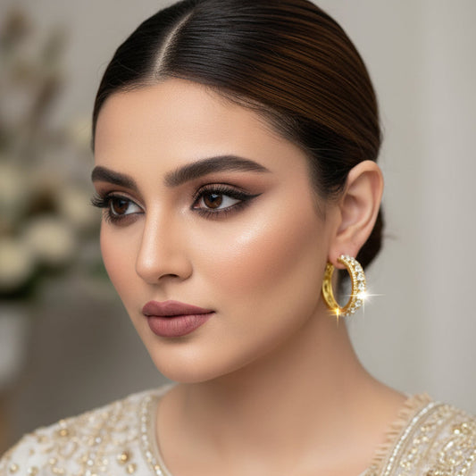 Gold ring with diamonds on a black background, branded 'Saheli'.