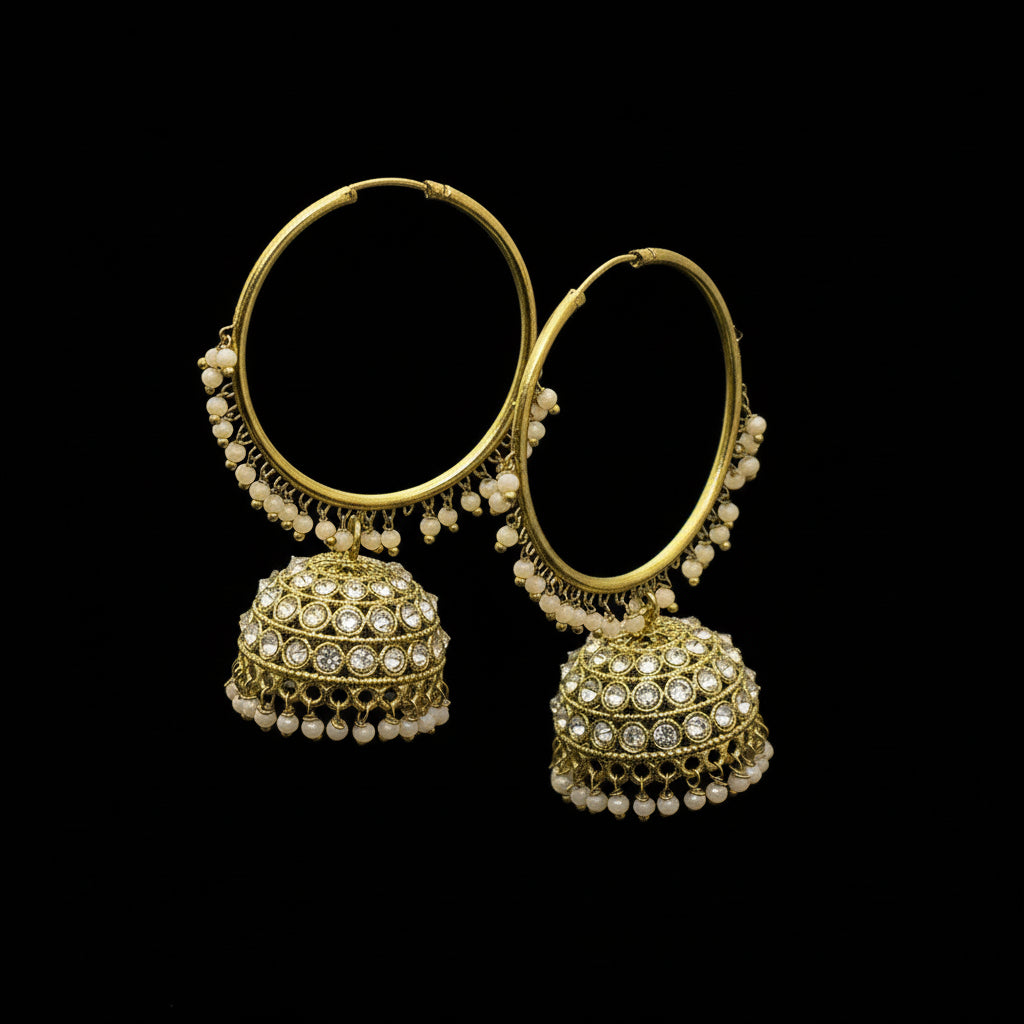 Gold hoop earrings with spherical embellishments on a black stand against a gray background.