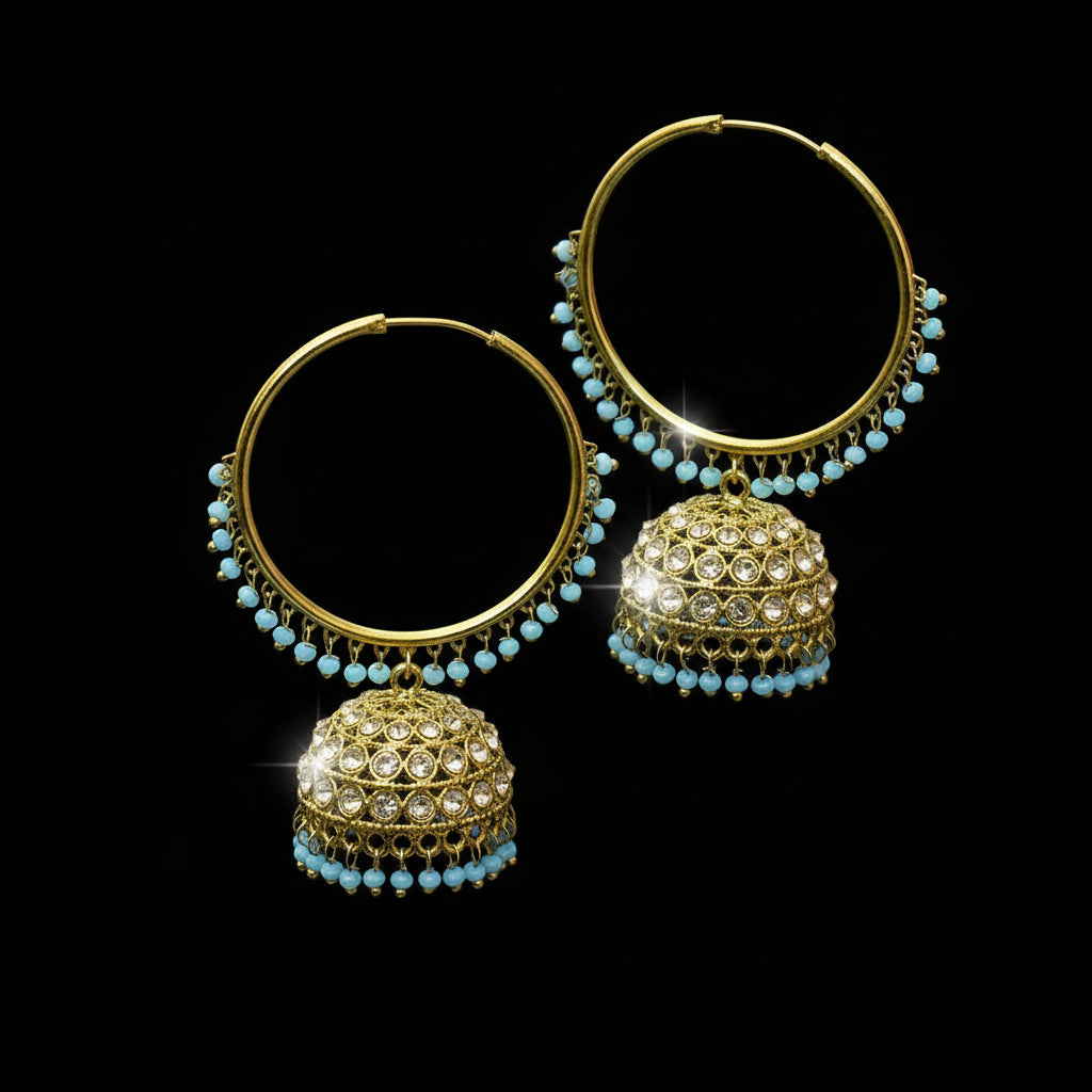 Gold hoop earrings with spherical embellishments on a black stand against a gray background, branded 'SAHELI'.
