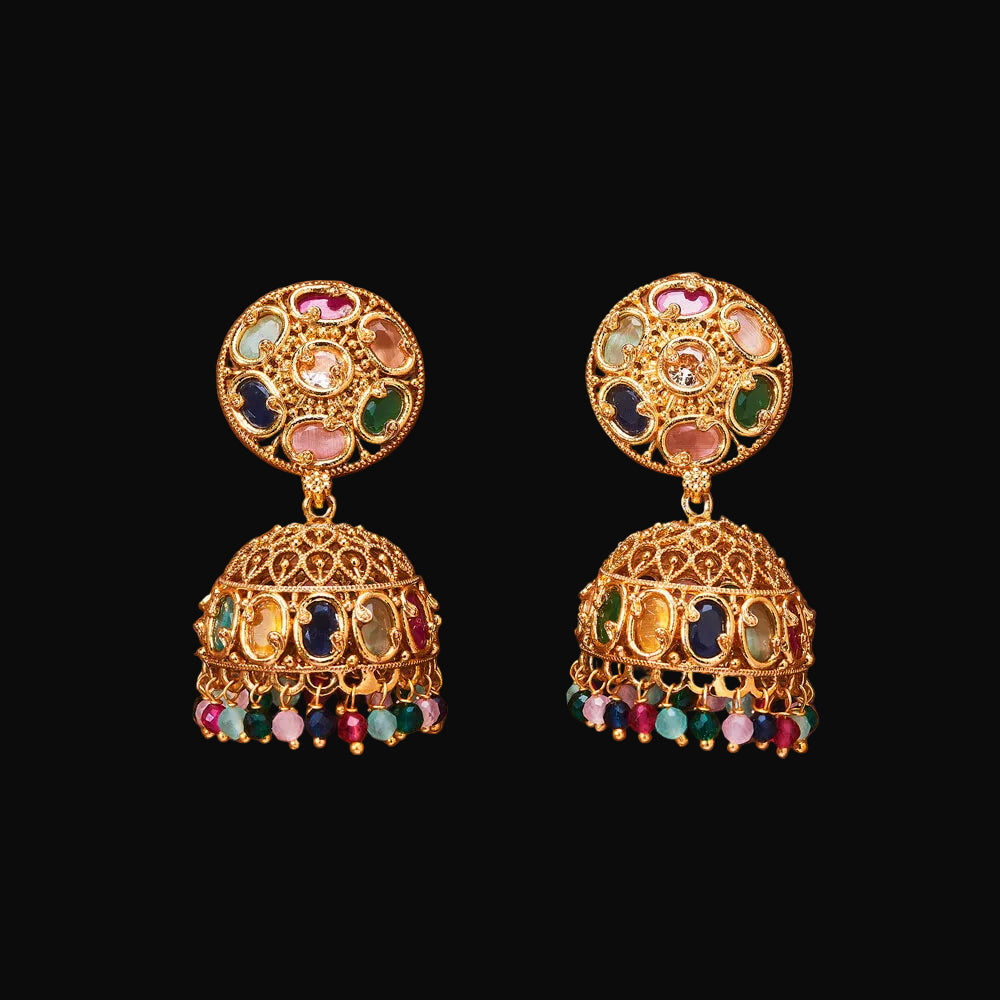 Pair of gold earrings with colorful gemstones on a brown background