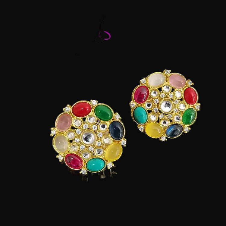 Colorful gemstone earrings with gold setting on a dark background, branded 'Saheli'.