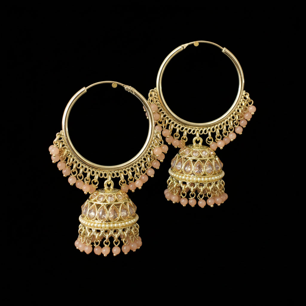 Gold hoop earrings with pink beads on a gray background, branded 'Saheli'.