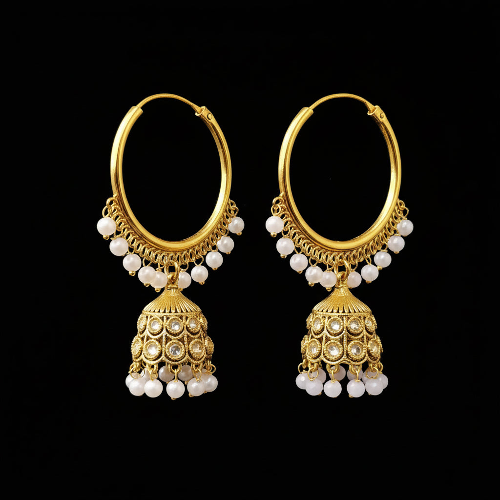 Gold hoop earrings with jhumka designs on a stand, branded 'Saheli'.