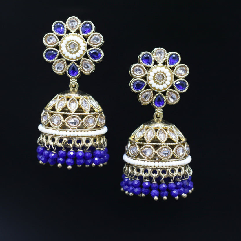 Pair of decorative earrings with blue and gold details on a black background
