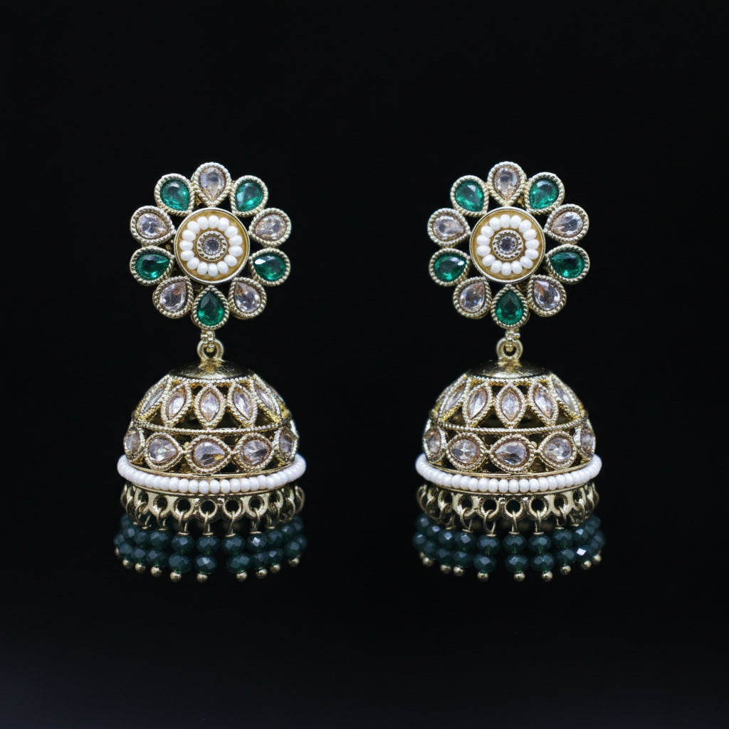 Pair of ornate earrings with floral top and bell-shaped bottom on a black background
