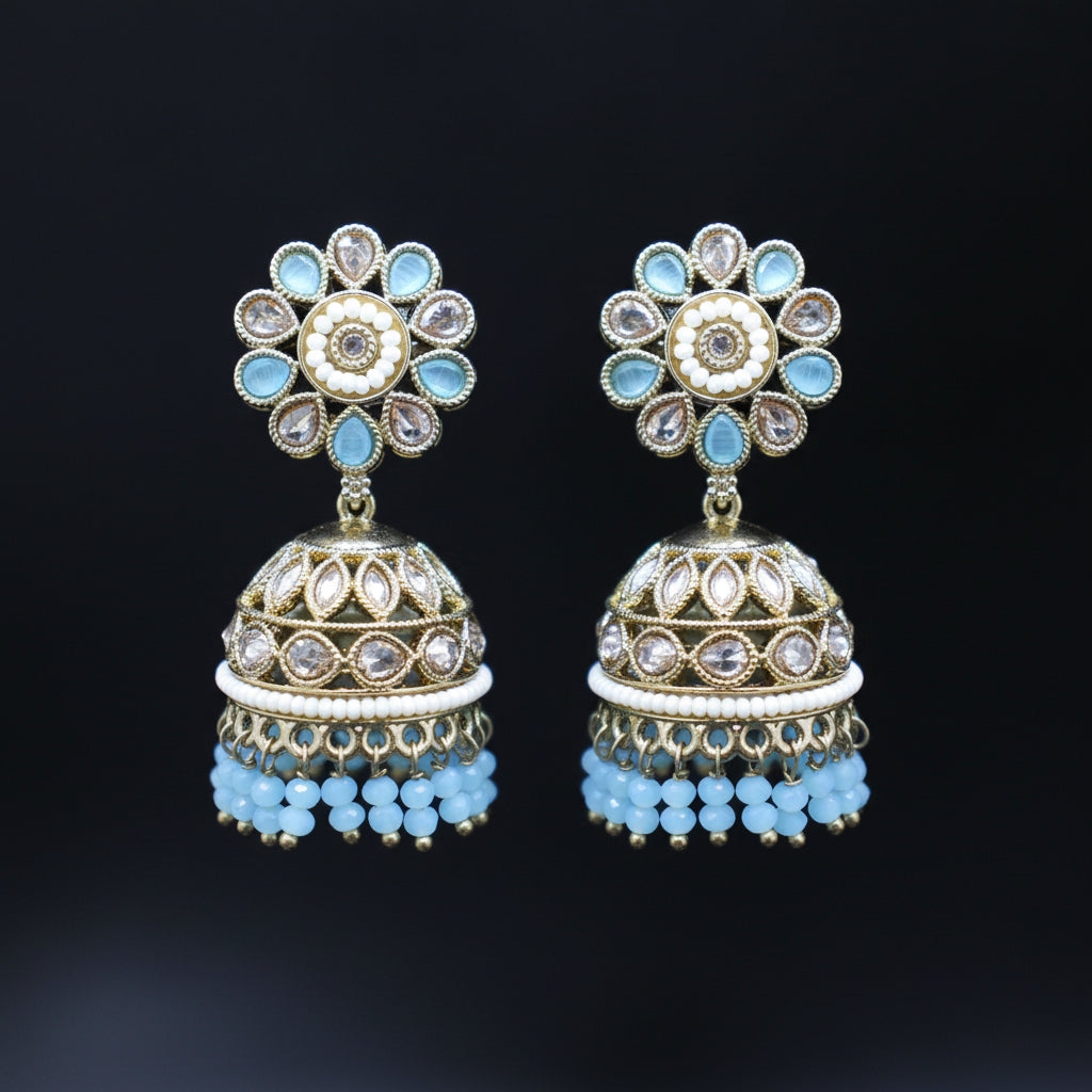 Decorative earrings with floral top and cylindrical bottom on a black background
