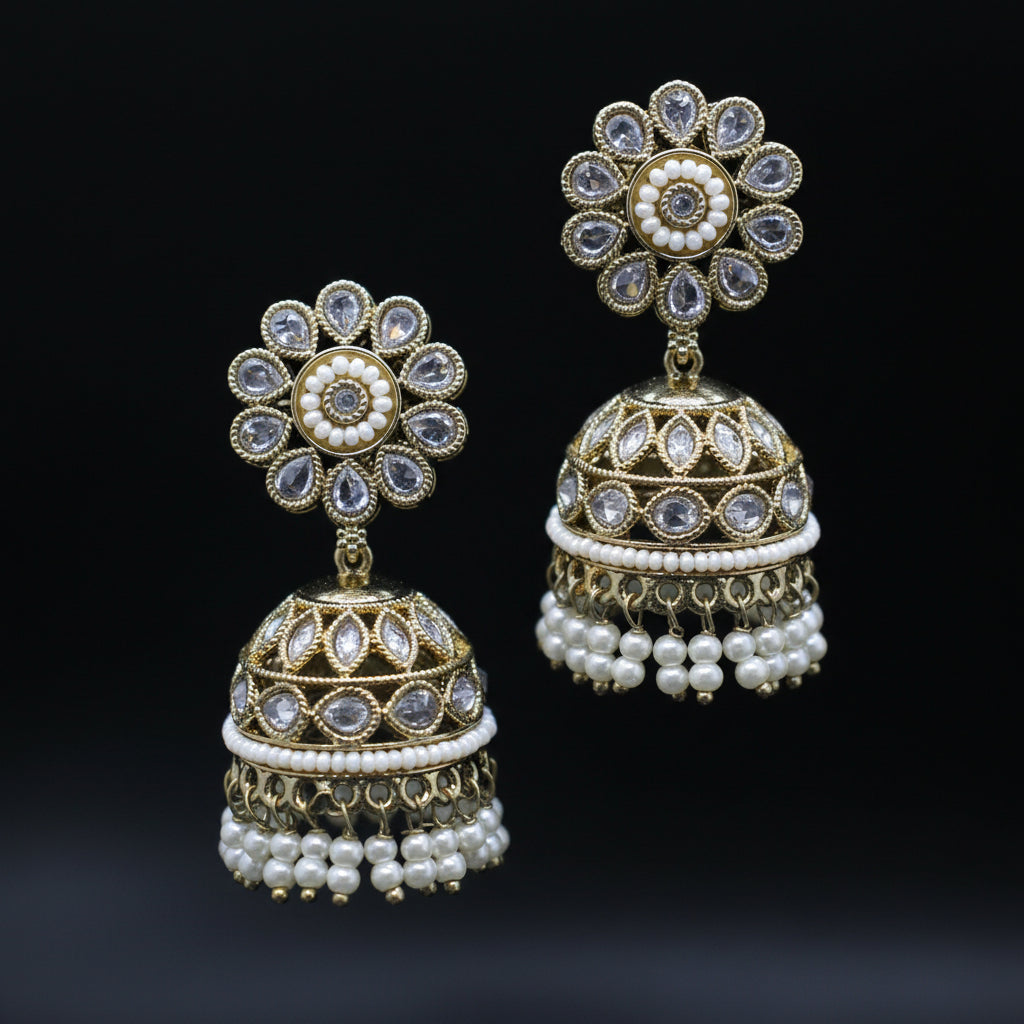 Pair of gold and pearl earrings on a black background