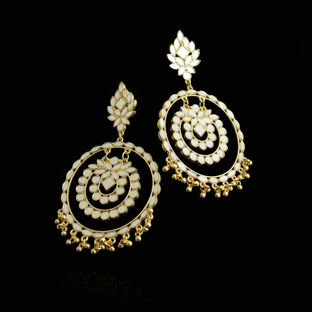 Pair of gold and pearl earrings on a black background