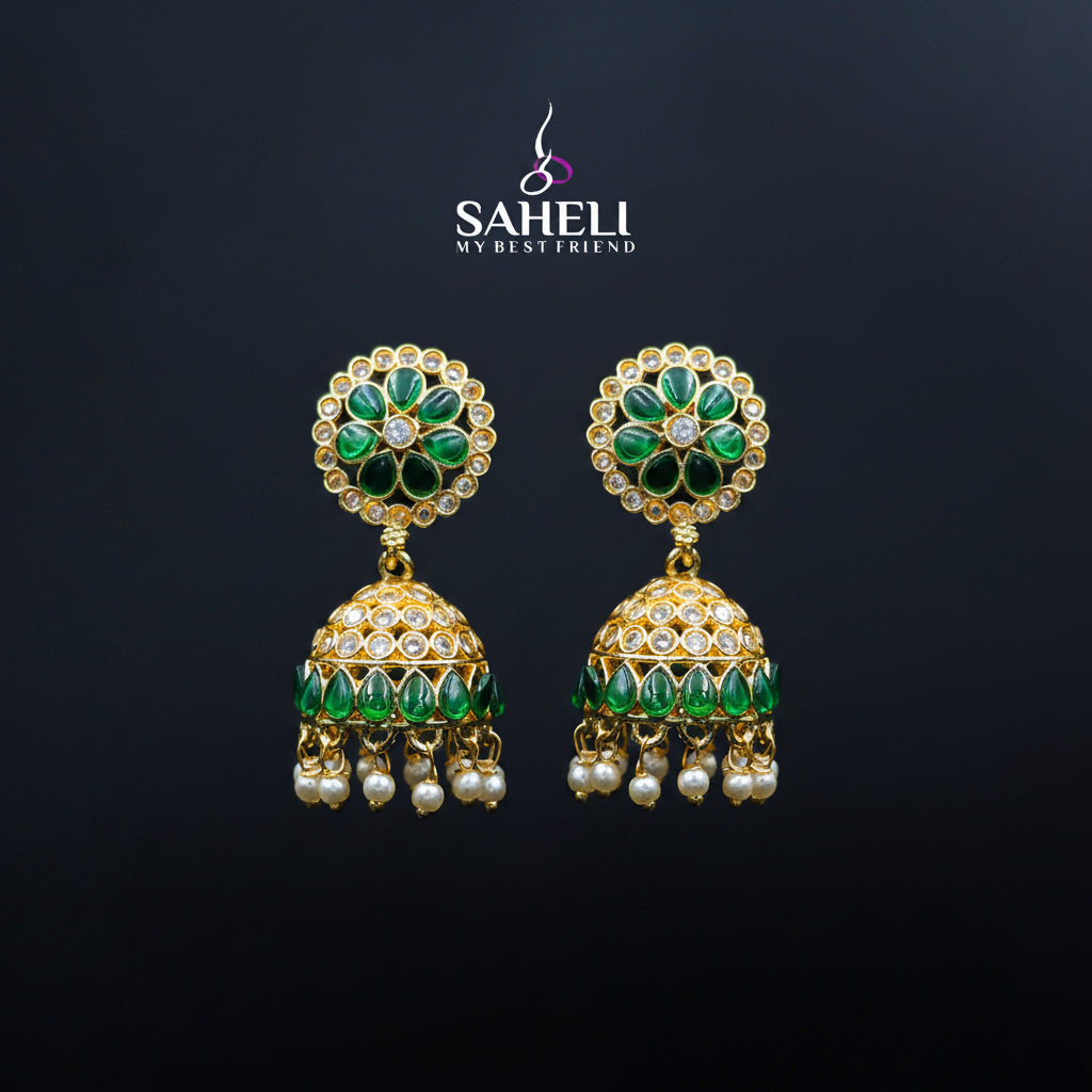 Gold and green earrings with 'Saheli' branding on a dark background