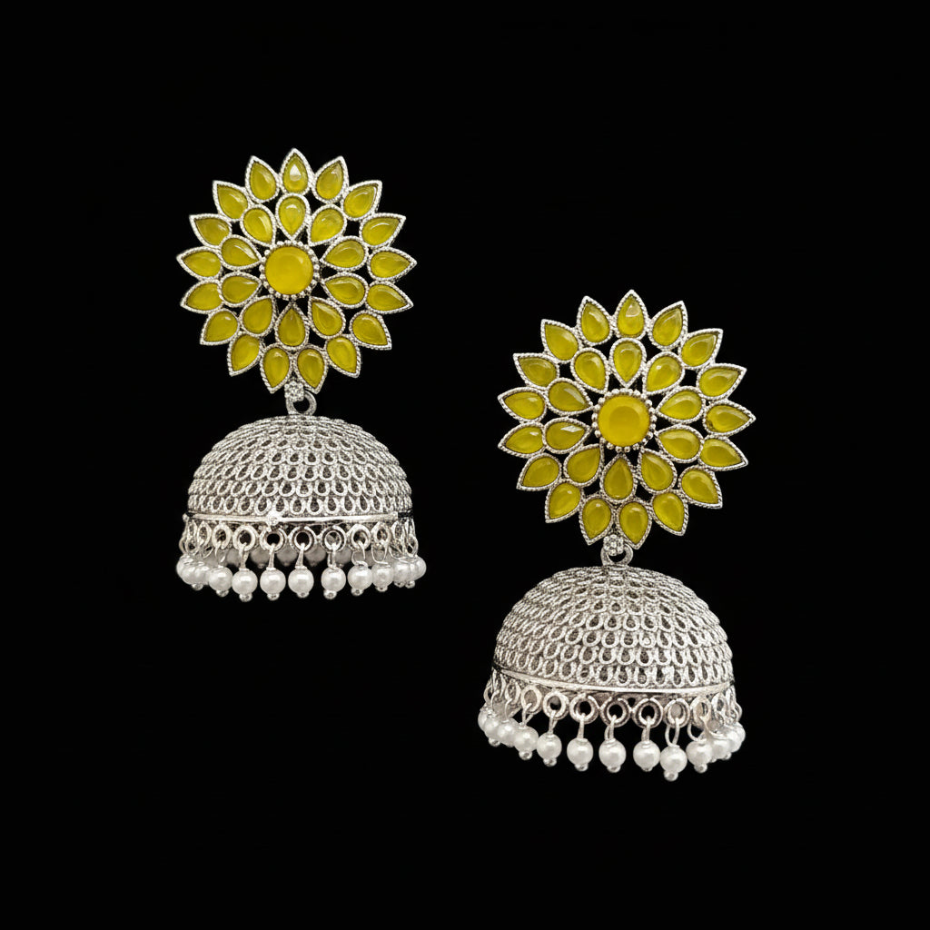 Floral design earrings with yellow stones and silver base on a gray background