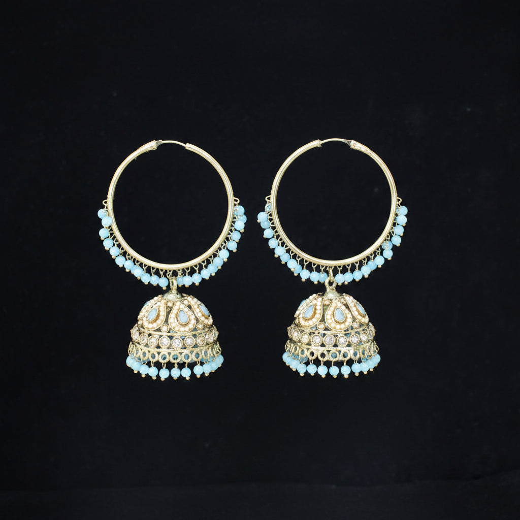 Pair of gold hoop earrings with turquoise stones on a black background