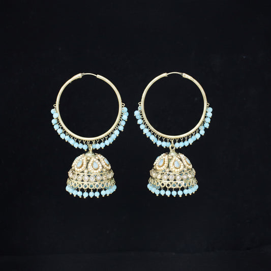 Pair of gold hoop earrings with turquoise stones on a black background