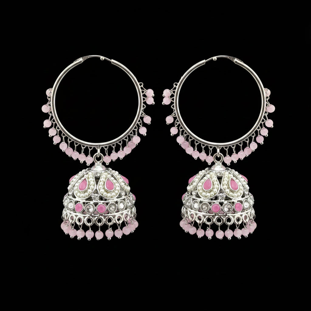 Pair of silver hoop earrings with pink beads on a gray stand.