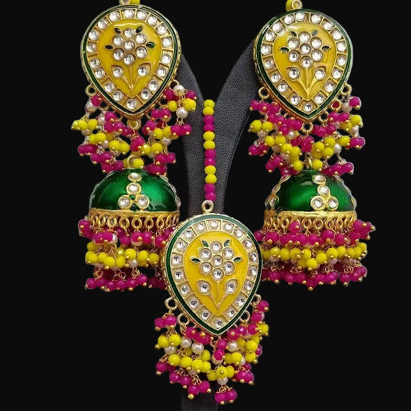 Colorful earrings with intricate designs on a gray background, featuring the brand 'SAHELI'.