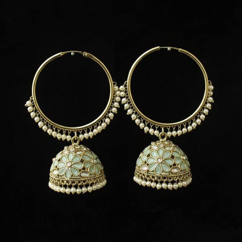Pair of gold and pearl earrings with floral designs on a black background