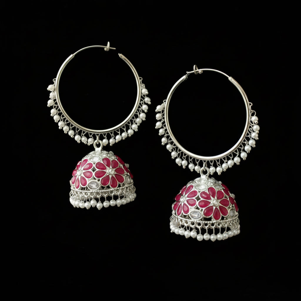 Pair of silver hoop earrings with red floral designs on a black background