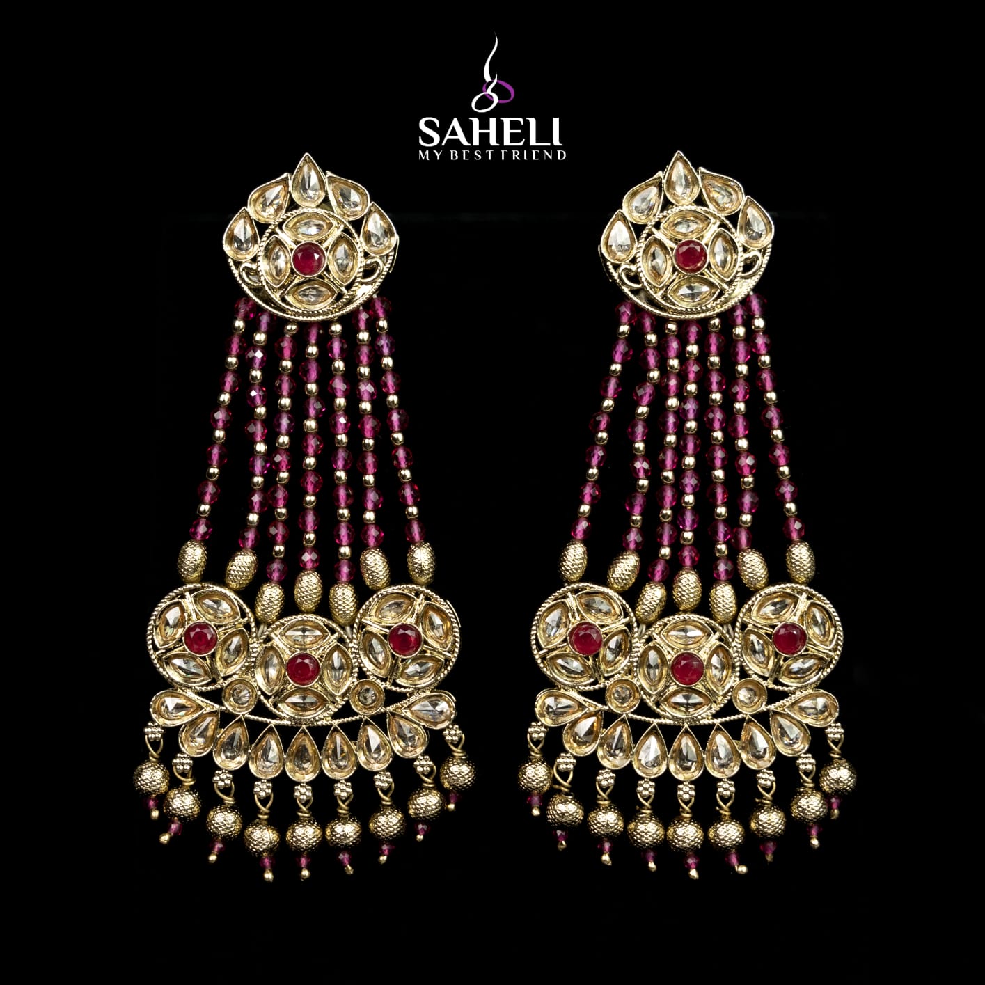 Ornate gold and red beaded earrings with 'Saheli' branding on a black background