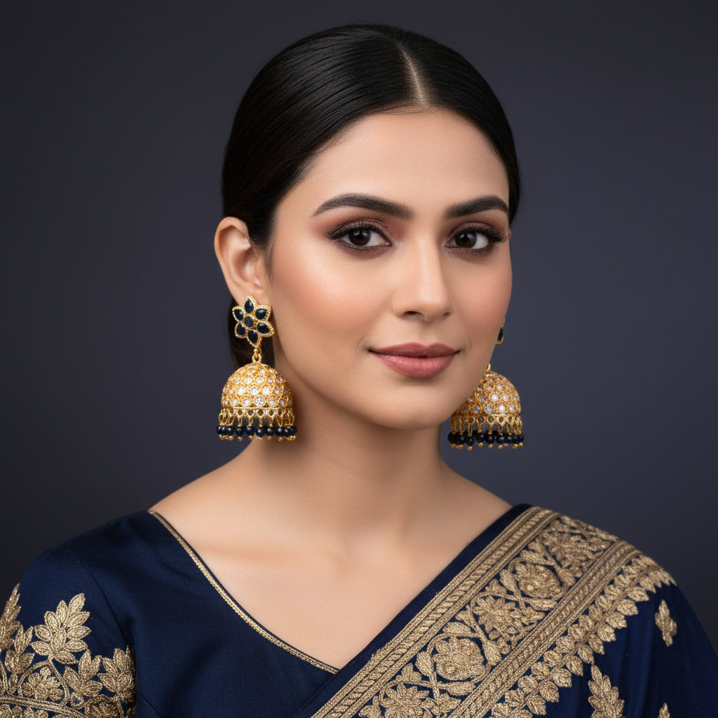 Gold and black earrings on a dark background with 'Saheli' branding.