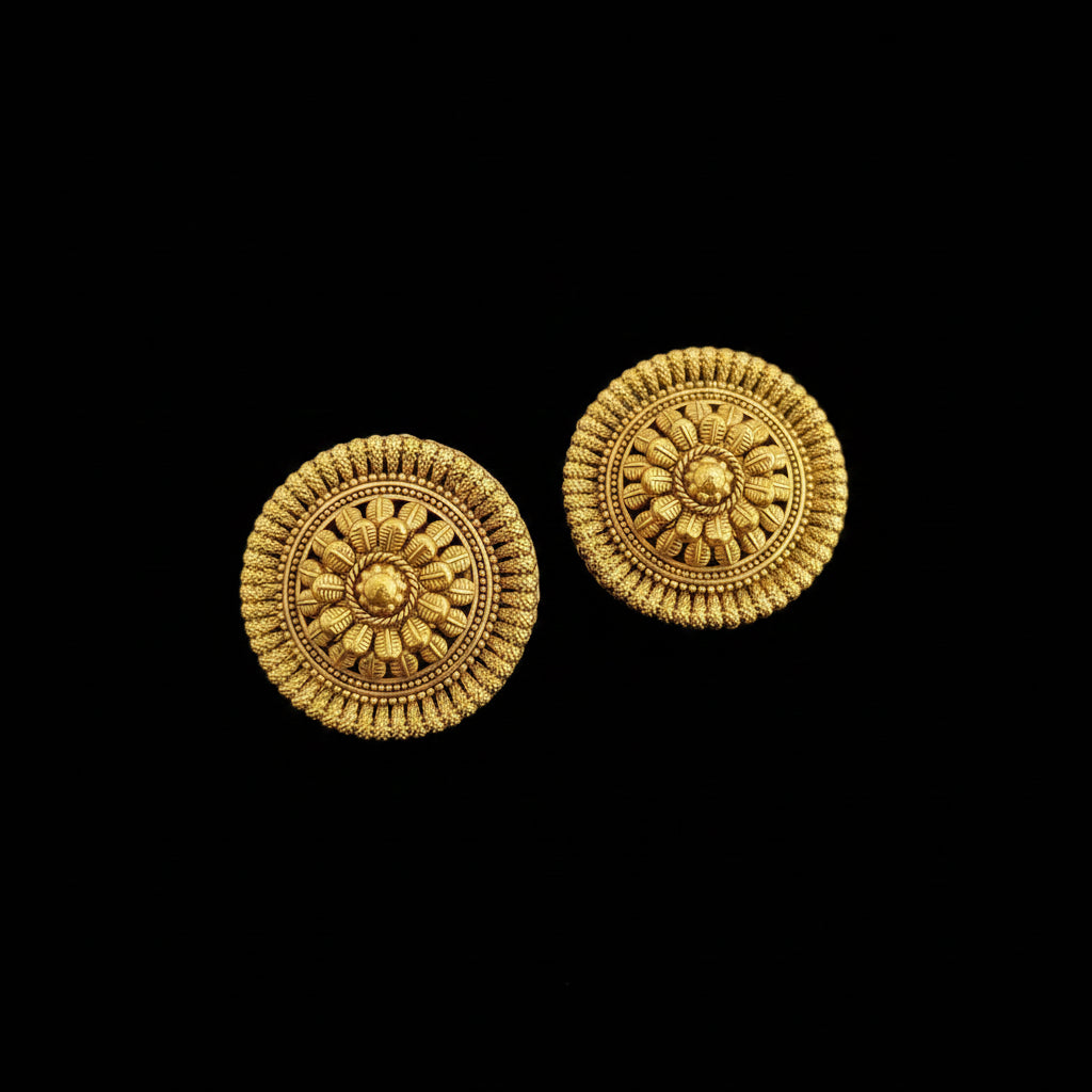 Pair of gold circular earrings on a dark background