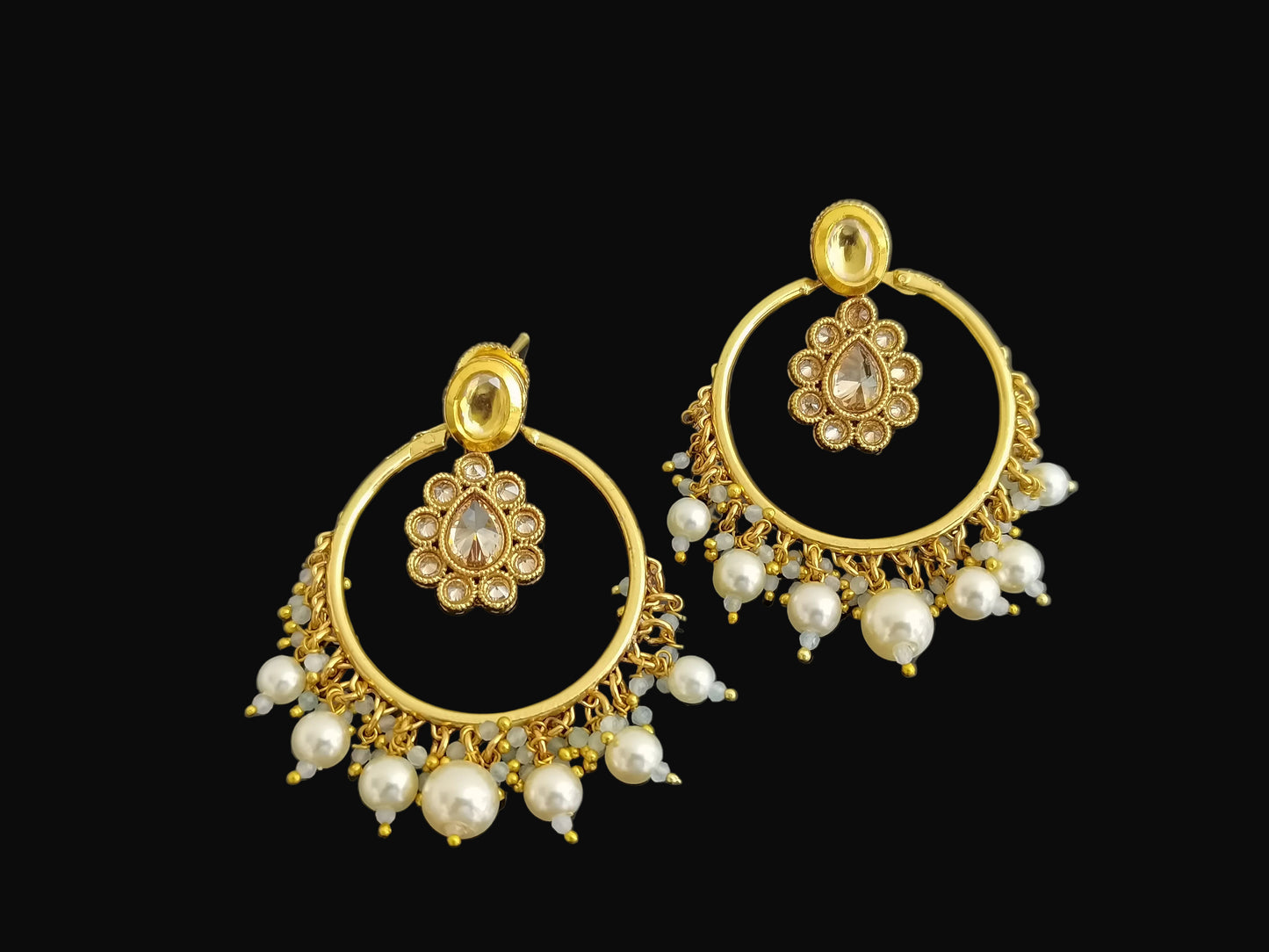 Gold hoop earrings with pearl accents on a black background