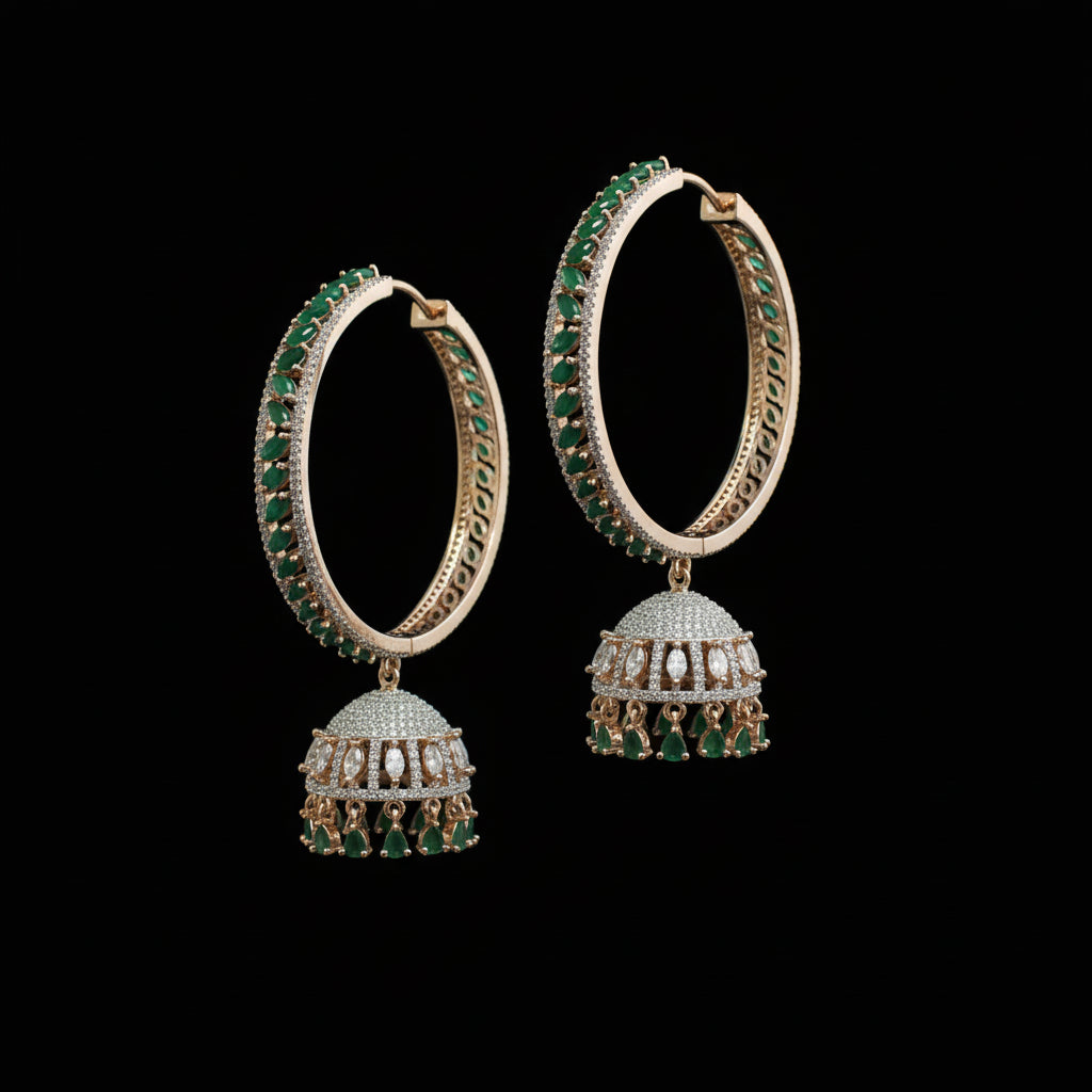 Pair of gold hoop earrings with green gemstones on a black stand against a gray background.